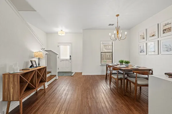 a view of a livingroom with furniture wooden floor and chandelier