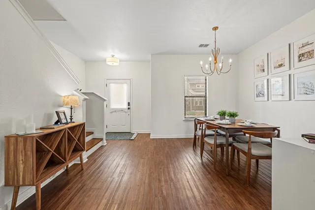 a view of a livingroom with furniture wooden floor and chandelier