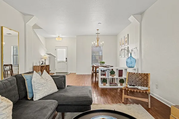 a living room with furniture and wooden floor