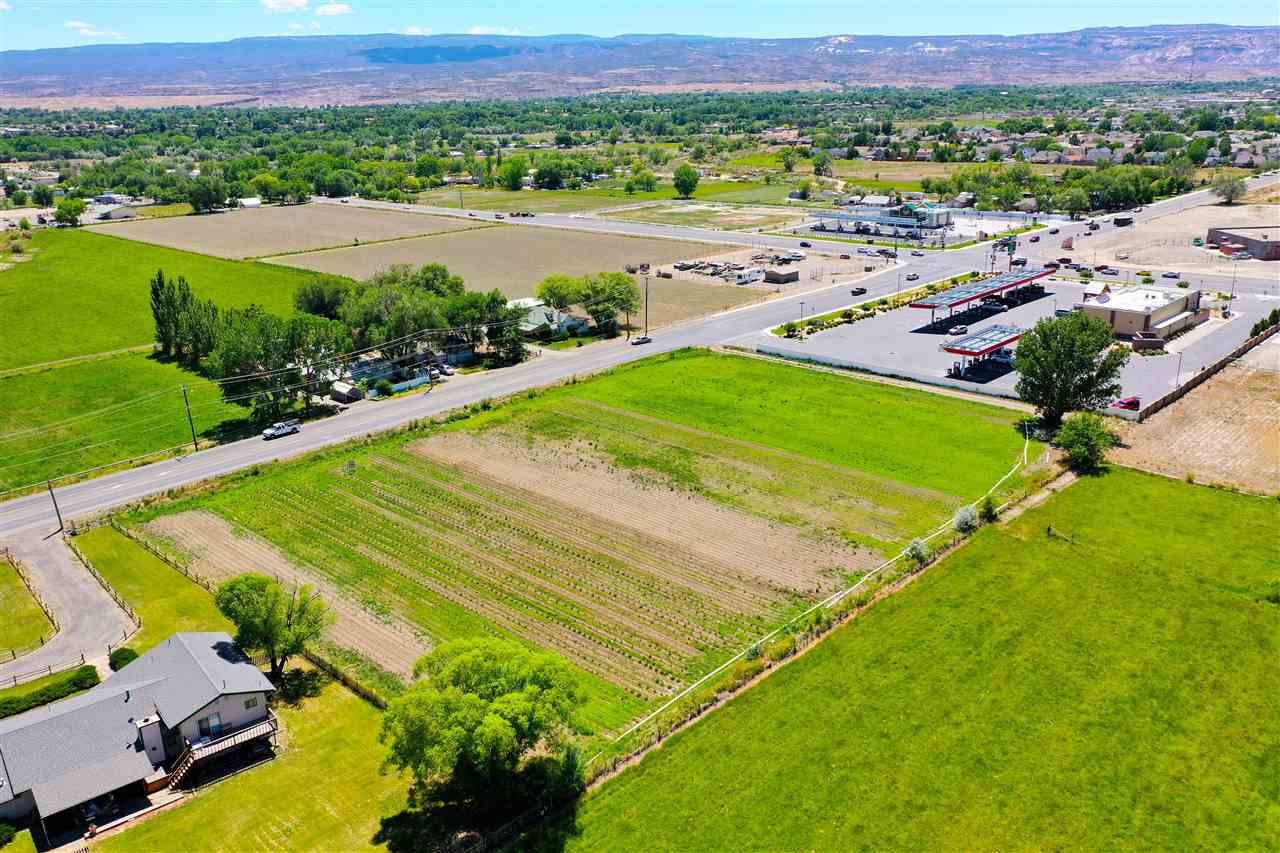 2910 D Road, Unit 3 2 AC Grand Junction, CO 81504 - Photo 6 of 11 an aerial view of a pool a yard and mountain view