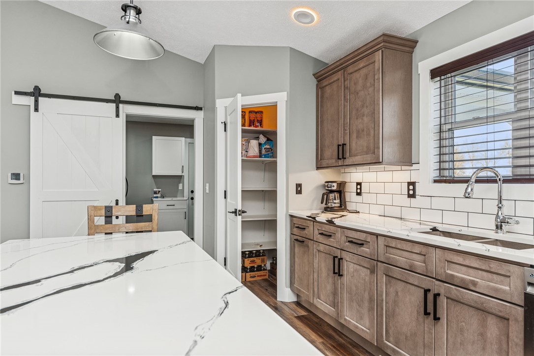 1602 Westboro Road Blanchester, OH 45107 - Photo 21 of 81 This modern kitchen features a spacious island and ample storage, ideal for culinary endeavors.