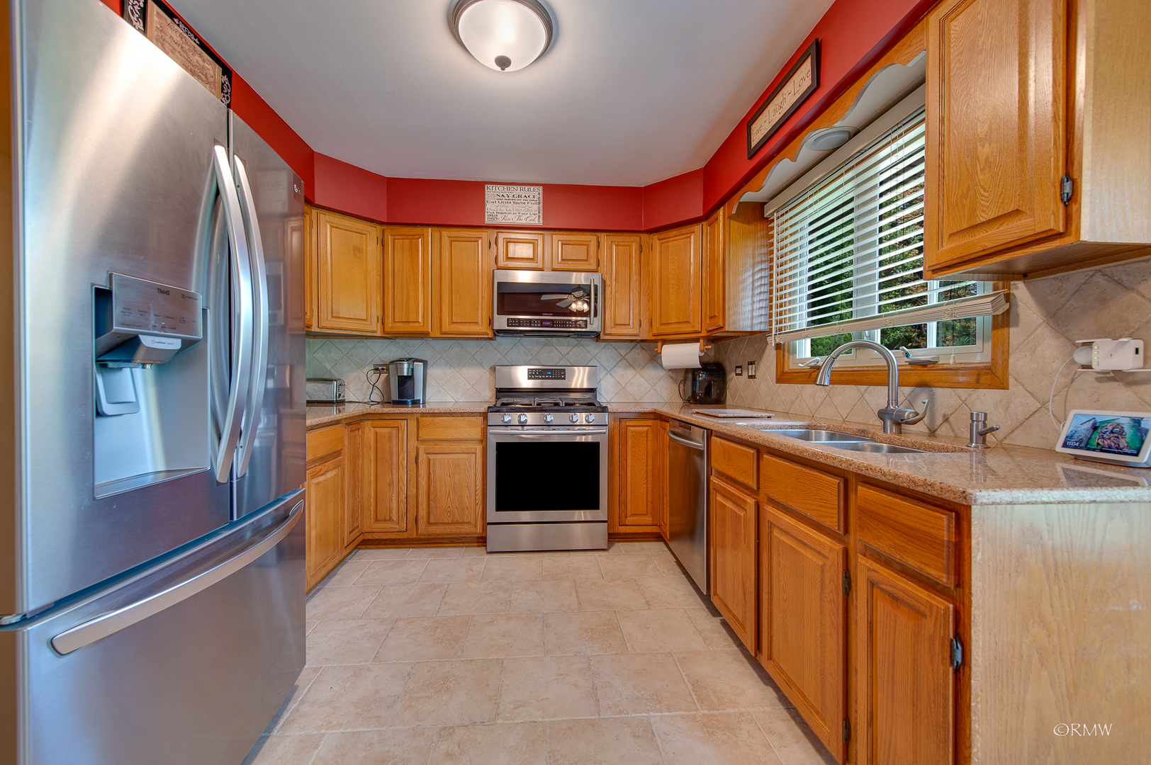 1550 Squire Lane Addison, IL 60101 - Photo 12 of 39 a kitchen with stainless steel appliances granite countertop a stove a sink and a refrigerator