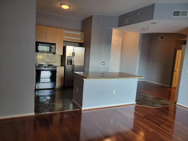 a kitchen with stainless steel appliances granite countertop a refrigerator and a sink
