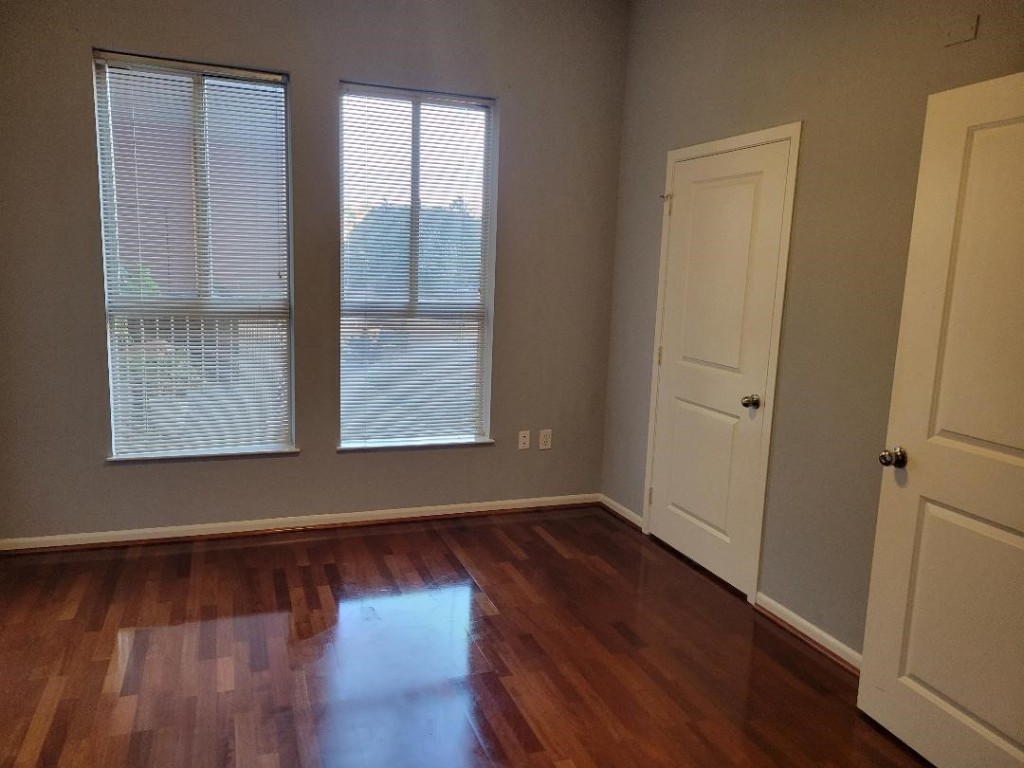 3505 Sage Road, Unit 211 Houston, TX 77056 - Photo 19 of 25 a view of an empty room with wooden floor and a window