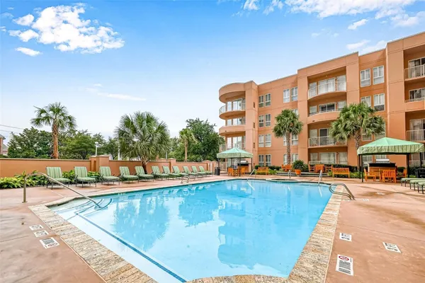 a view of a swimming pool with a lounge chair