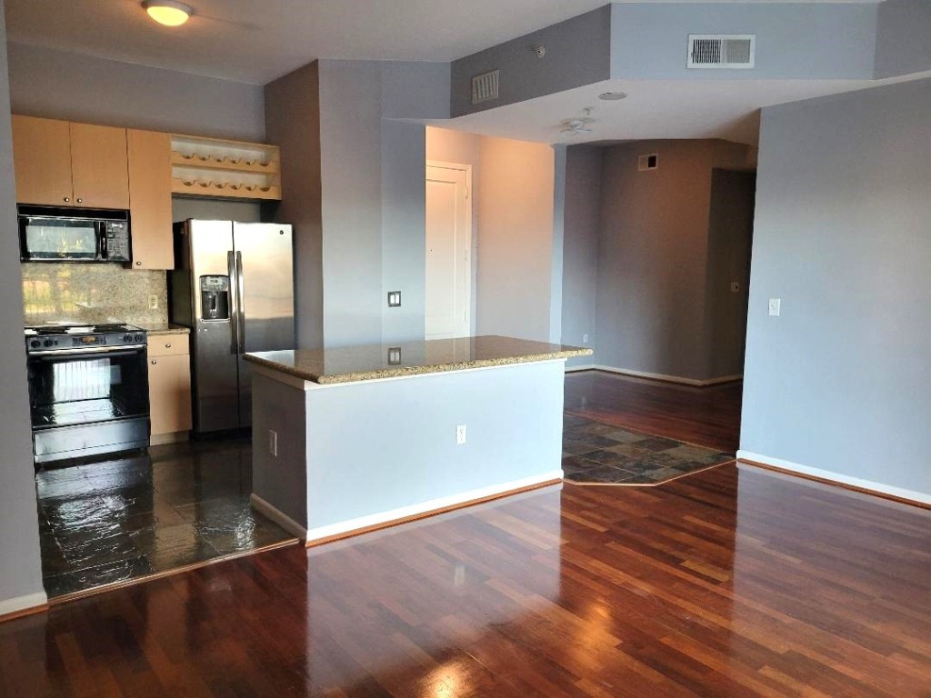 3505 Sage Road, Unit 211 Houston, TX 77056 - Photo 9 of 25 a kitchen with stainless steel appliances a refrigerator and a sink
