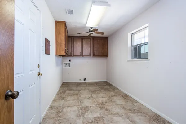 a view of a kitchen with a sink and cabinets