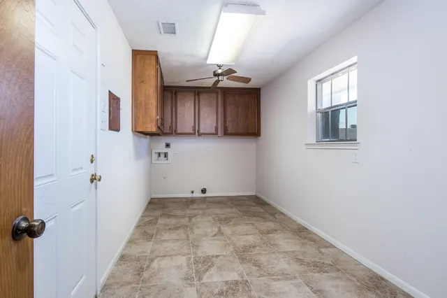 a view of a kitchen with a sink and cabinets