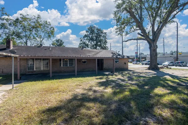 a view of a house with a yard and tree s