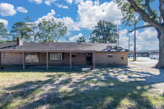 a view of a house with a yard and sitting area
