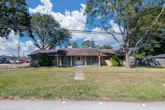 a front view of a house with a yard and a garage