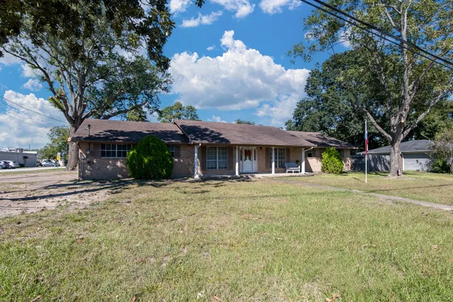 a front view of a house with a garden