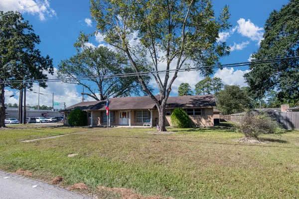 a view of a house with a yard and sitting area