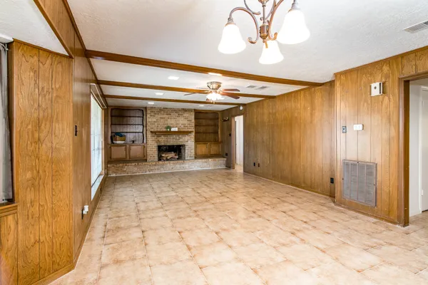a view of a hallway with wooden shelves