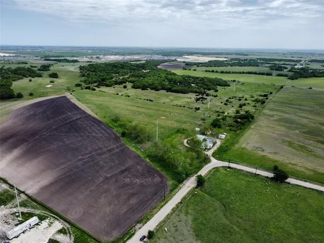 an aerial view of a houses with outdoor space