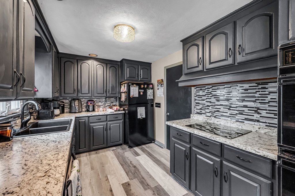 31 Stone Path Lane West Springfield, MA 01089 - Photo 13 of 31 a kitchen with kitchen island granite countertop a sink stove and refrigerator