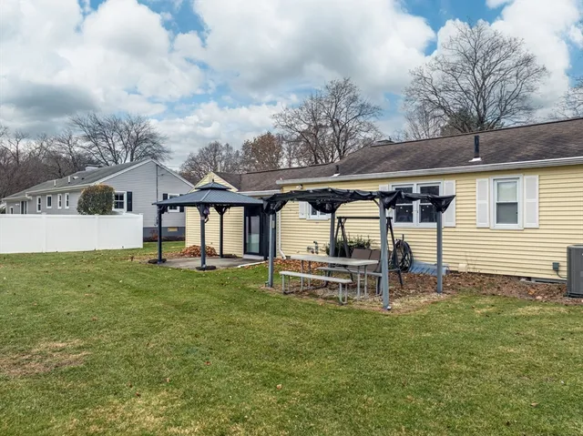 a backyard of a house with table and chairs