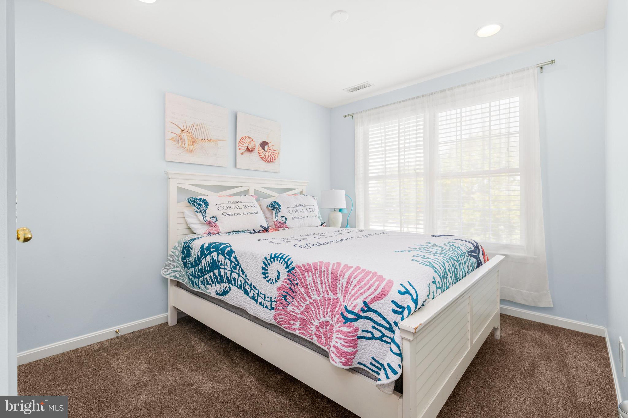 617 Salt Spray Road, Unit B Ocean City, MD 21842 - Photo 50 of 72 a bedroom with a bed and window