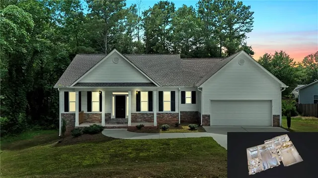 a front view of a house with a yard and porch