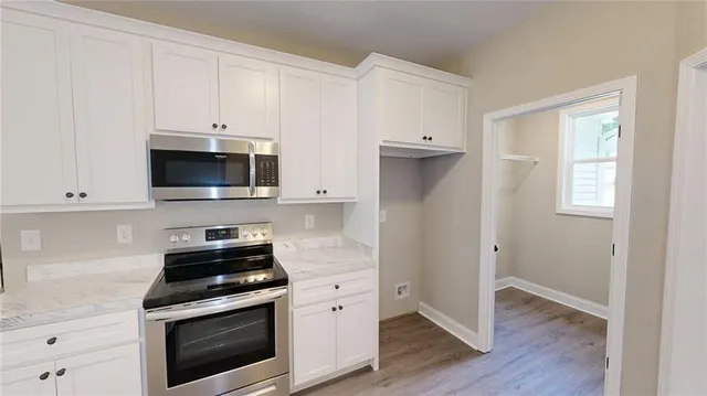 a view of kitchen with cabinets and wooden floor