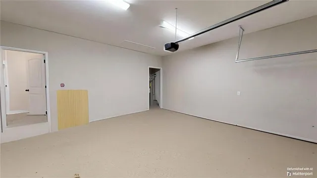 an empty room with wooden floor and window