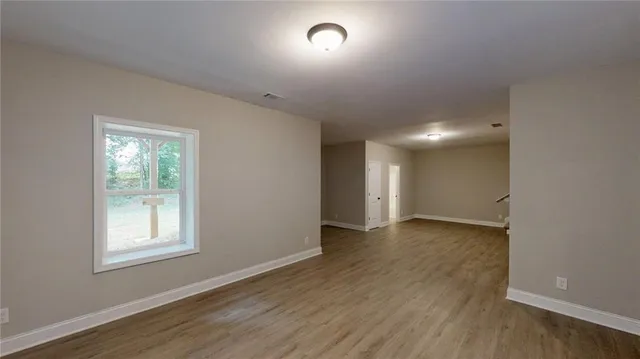 a view of empty room with wooden walls