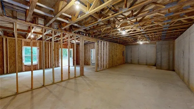 an aerial view of a house with a yard and trees all around