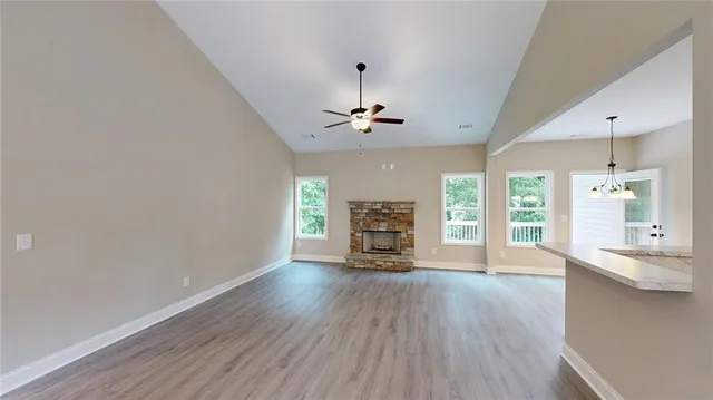 a dining room with furniture potted plants and wooden floor