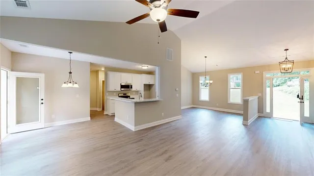 a view of an room with wooden floor and windows