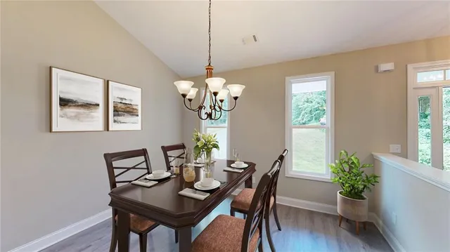 a view of a room with wooden floor and chandelier