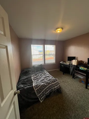 a bed sitting in a bedroom next to a window