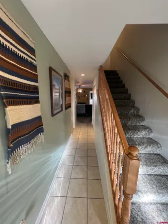 a view of entryway and hall with wooden floor