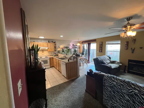 a living room with furniture and a kitchen