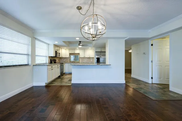 a view of a kitchen with cabinets and stainless steel appliances