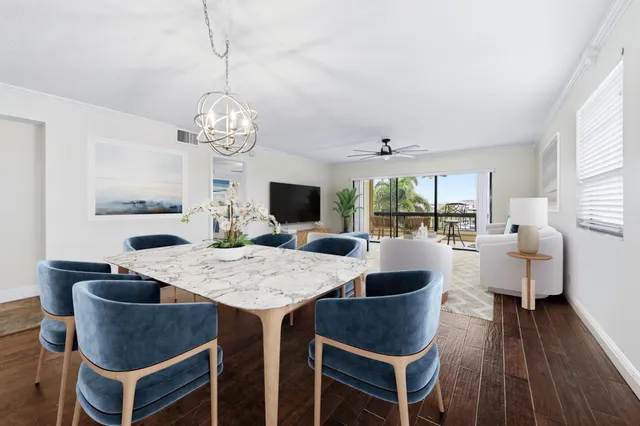 a view of a dining room with furniture wooden floor and chandelier
