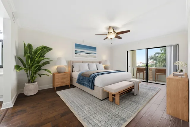 a spacious bedroom with a bed a couch and a potted plant