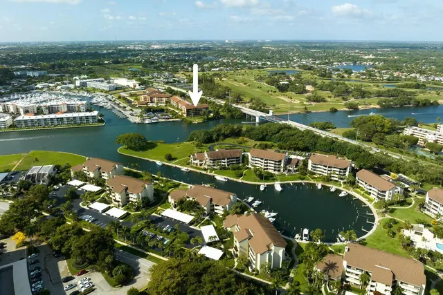 an aerial view of residential houses with outdoor space and lake view