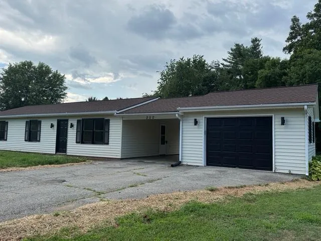 an empty room with cabinet and mirror