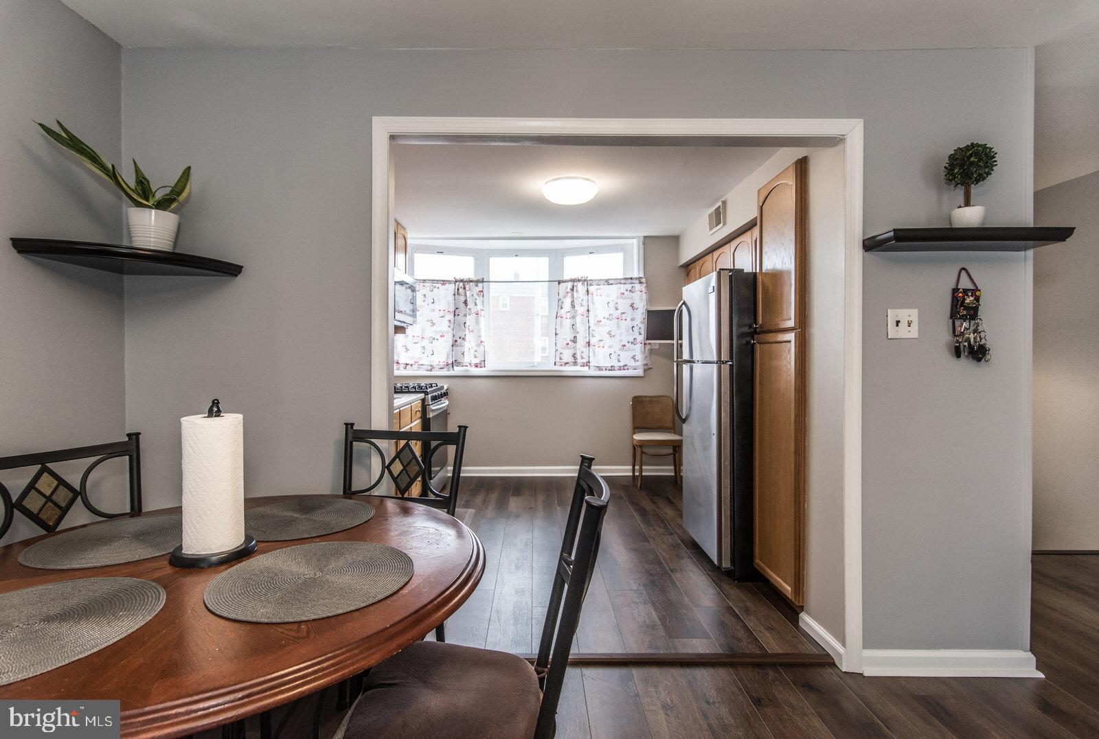 12138 Barbary Road Philadelphia, PA 19154 - Photo 17 of 71 a kitchen with sink refrigerator dining table and chairs