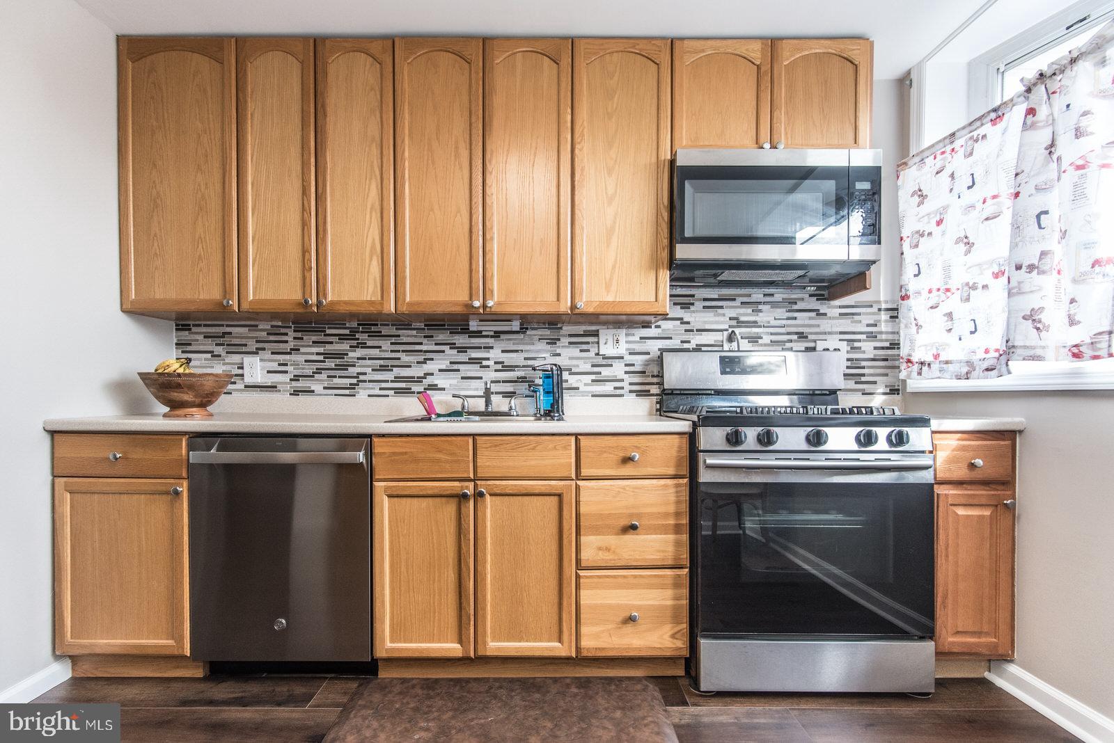 12138 Barbary Road Philadelphia, PA 19154 - Photo 19 of 71 a kitchen with stainless steel appliances granite countertop a stove a sink and a microwave