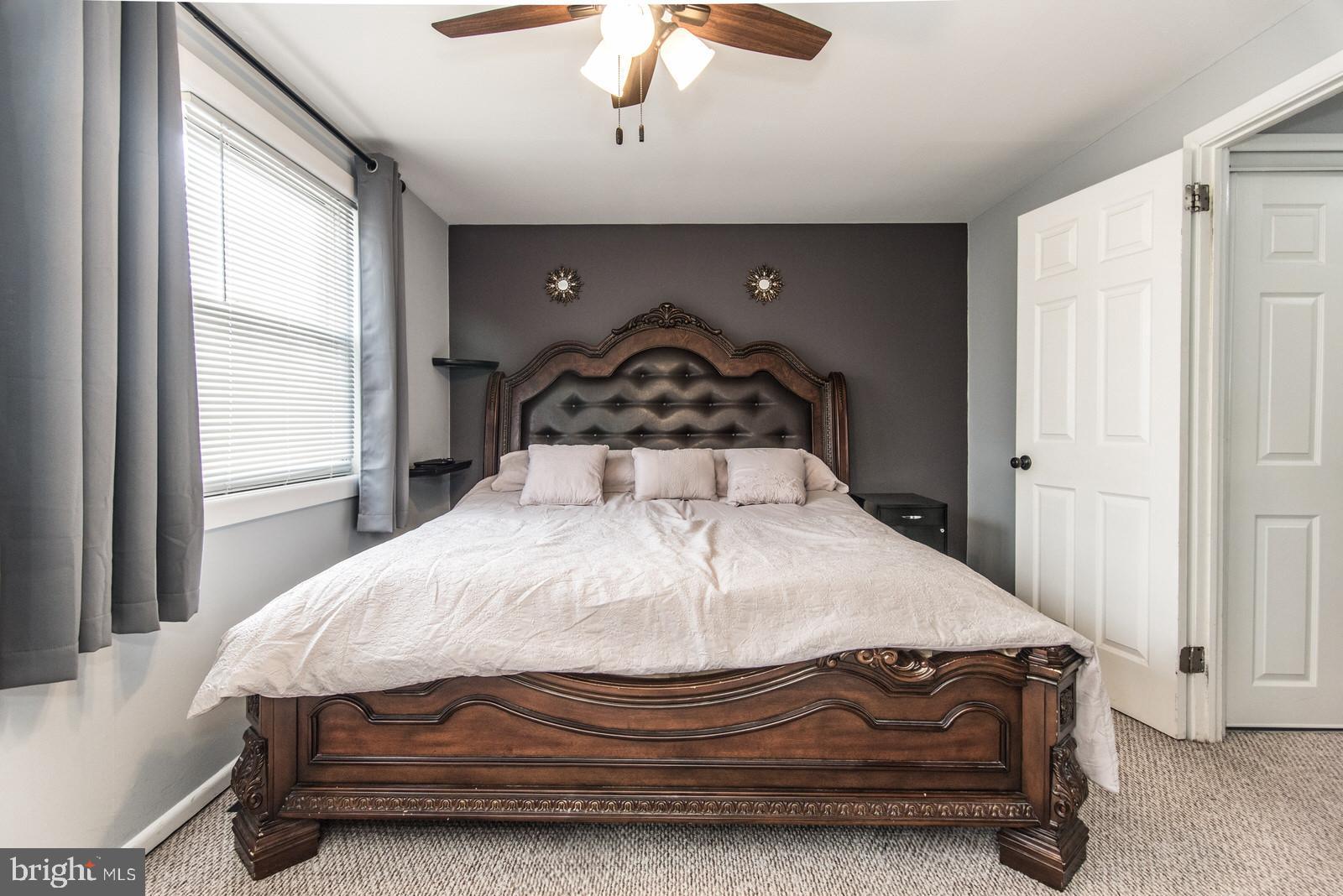 12138 Barbary Road Philadelphia, PA 19154 - Photo 28 of 71 a bedroom with a bed and a chandelier