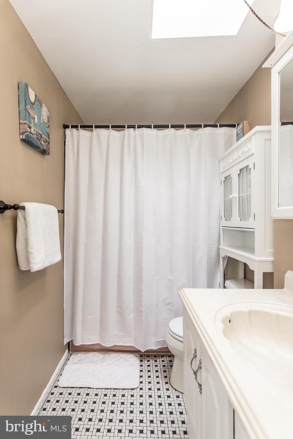12138 Barbary Road Philadelphia, PA 19154 - Photo 34 of 71 a bathroom with a sink a toilet and a shower curtain