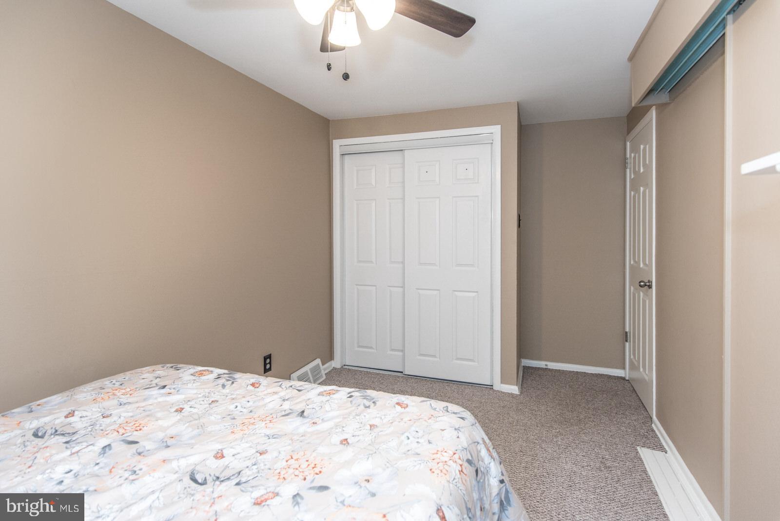 12138 Barbary Road Philadelphia, PA 19154 - Photo 41 of 71 a bedroom with a bed and a chandelier fan
