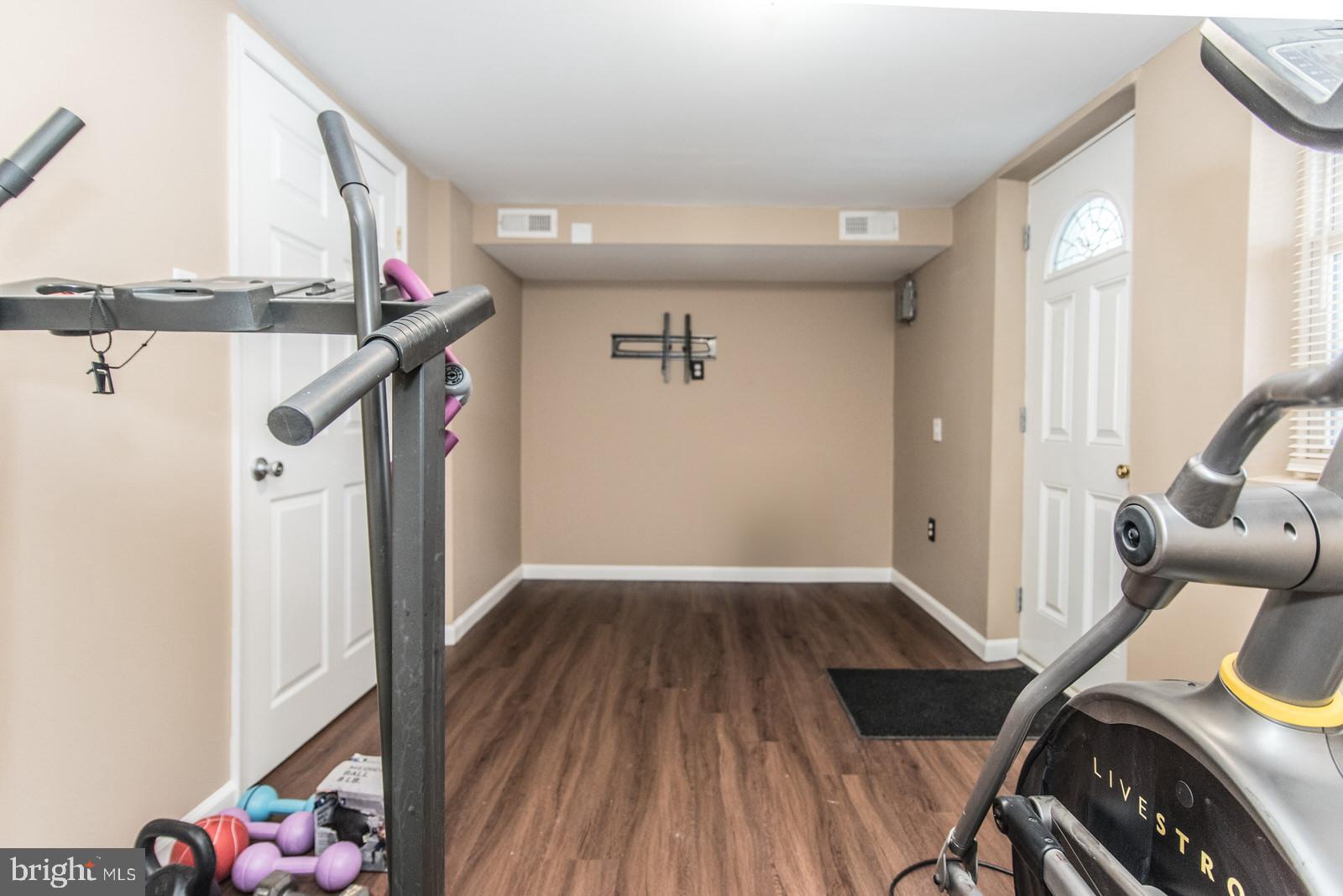 12138 Barbary Road Philadelphia, PA 19154 - Photo 53 of 71 a view of a hallway to a livingroom with wooden floor and staircase