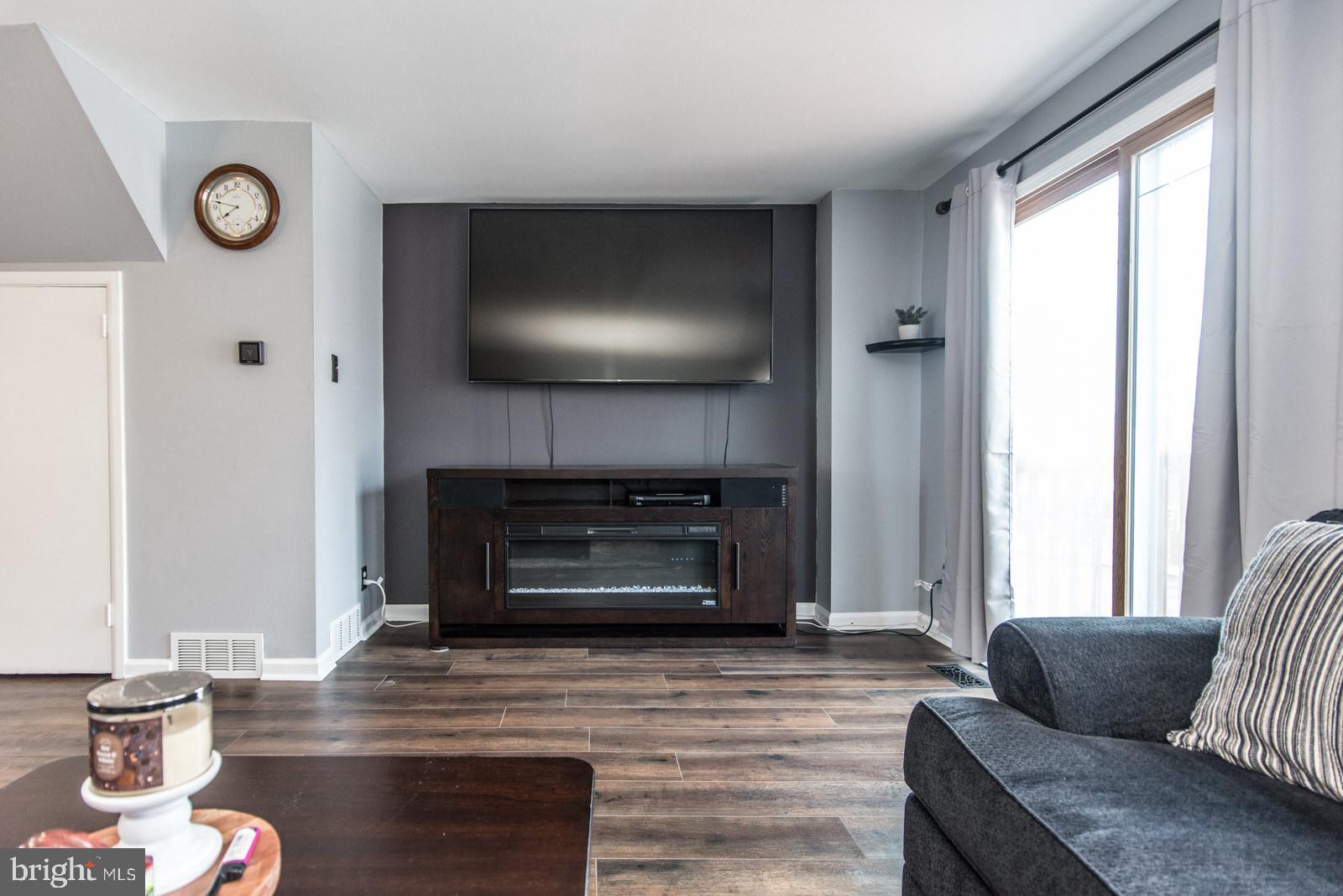 12138 Barbary Road Philadelphia, PA 19154 - Photo 9 of 71 a living room with furniture a flat screen tv and a fireplace