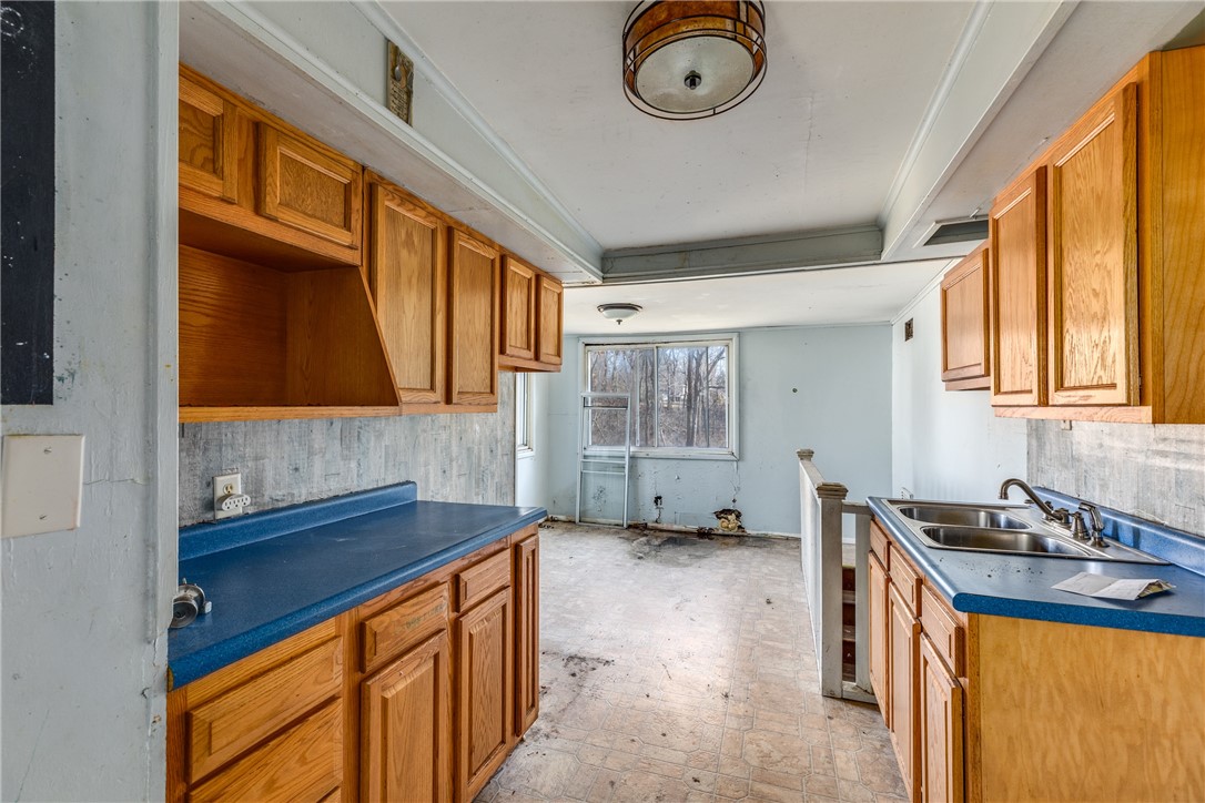 38 Norwood Drive Decatur, IL 62521 - Photo 17 of 32 a kitchen with a sink a stove cabinets and a window