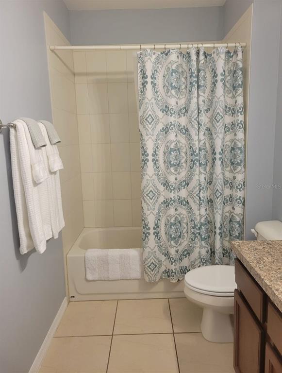 4623 Kalispell Road Kissimmee, FL 34758 - Photo 5 of 6 a bathroom with a toilet and shower