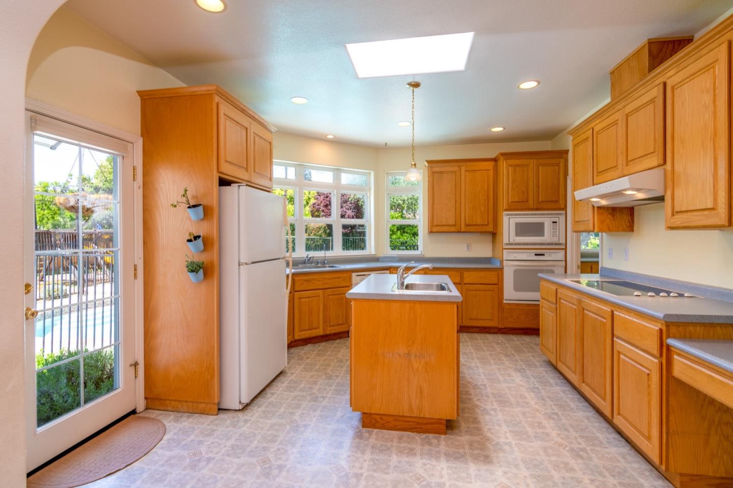 661 Cambrian Drive Campbell, CA 95008 - Photo 8 of 31 a kitchen with stainless steel appliances granite countertop a refrigerator a oven a sink dishwasher and wooden cabinets with wooden floor