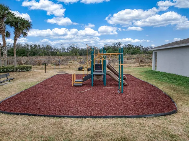 a view of a backyard with swimming pool