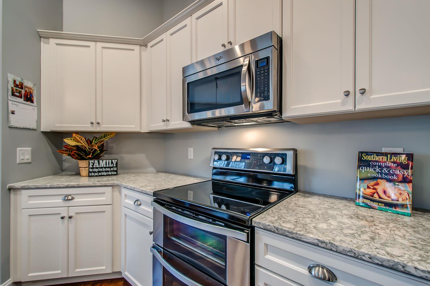 5705 Hopewell Ridge Road Franklin, TN 37064 - Photo 11 of 30 a kitchen with stainless steel appliances granite countertop a stove and a microwave